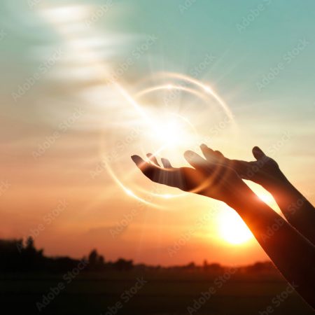 .Woman hands praying for blessing from god on sunset background